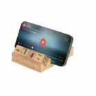 Smartphone on a wooden stand with a digital video playing, and a perpetual calendar date: Oct 14.