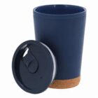 Navy blue travel mug with a cork base and a matching removable lid placed beside it.