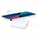 Smartphone wirelessly charging on a white charging pad against a white background.