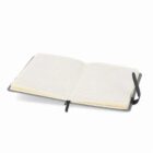 An open lined notebook with a gray cover and a black ribbon bookmark.
