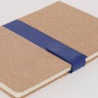 Notebook with a brown cover and a blue elastic band around it.