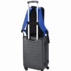 Backpack attached to a wheeled suitcases extended handle.
