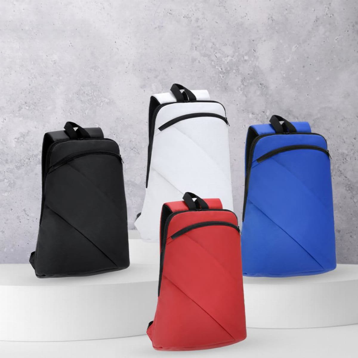 Four backpacks in black, white, red, and blue on a tiered white platform.