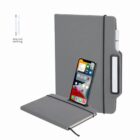 A smartphone and pen holder embedded in a gray notebook cover.