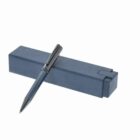 A blue pen resting on a matching rectangular box against a white background.