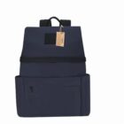 Dark backpack with front pocket and luggage tag, set against a white background.
