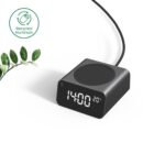 Black digital clock with wireless charging pad and recycled aluminum label on a white background.