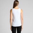 Woman in a white tank top and black jeans, facing away against a gray background.