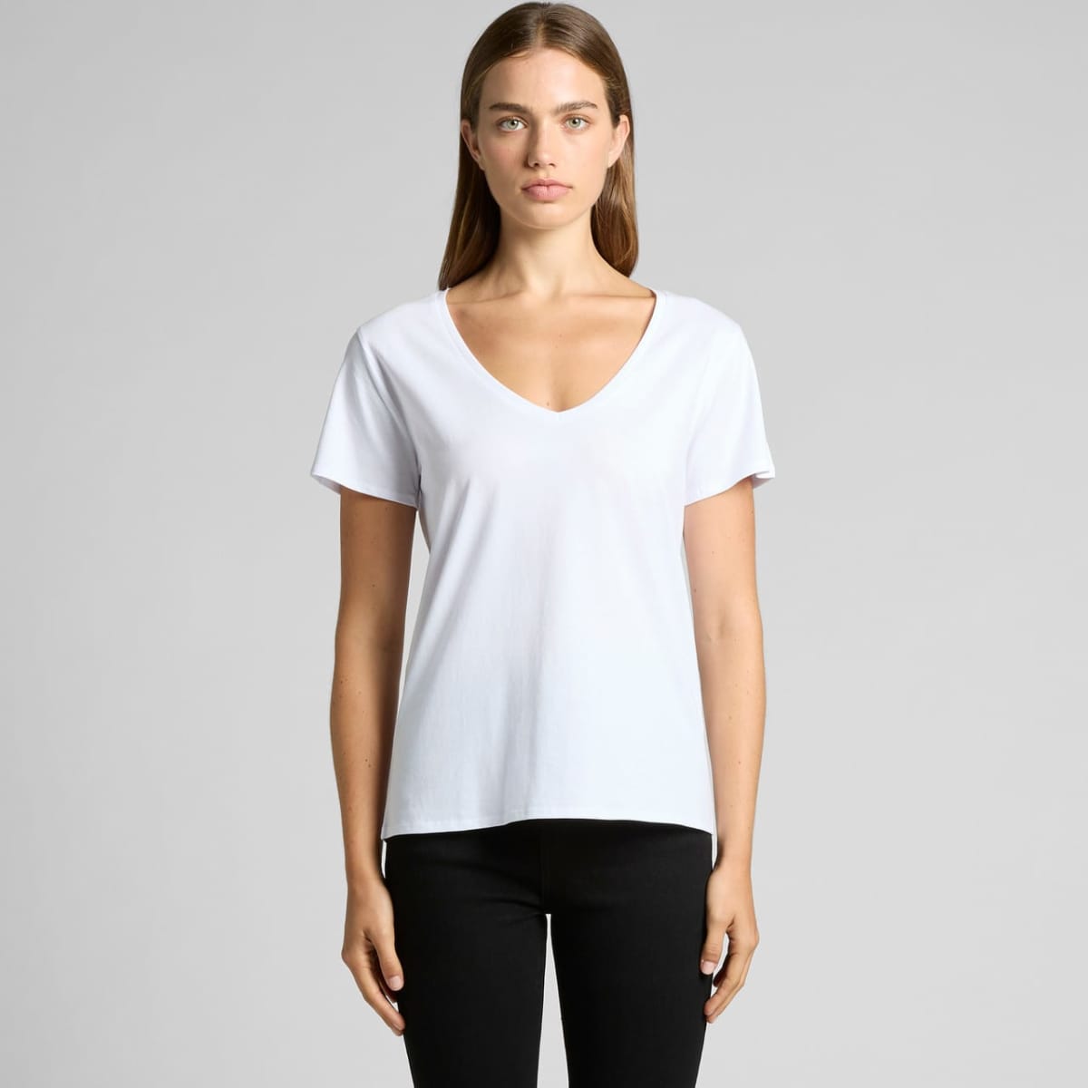 Person wearing a white V-neck T-shirt and black pants, standing against a plain background.