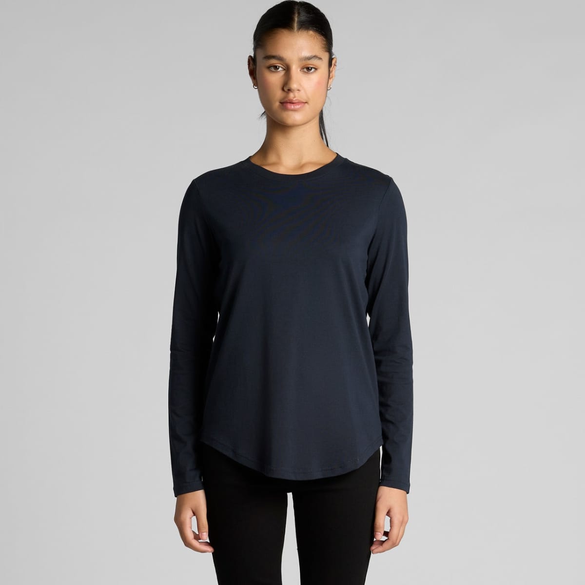 Person in a black long-sleeve shirt against a plain background.