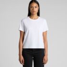 Woman in a plain white t-shirt and black pants standing against a light gray background.