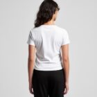 Woman with long brown hair wearing a white t-shirt and black pants, seen from the back.