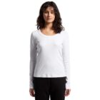 Woman wearing a white long-sleeve shirt and black pants, standing against a white background.