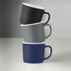 Three ceramic mugs, stacked horizontally in black, gray, and dark blue colors.