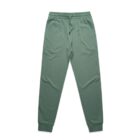 Green joggers with an elastic waistband and cuffs on a white background.