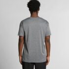 Man in a gray t-shirt and black shorts standing with his back to the camera.