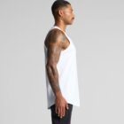 Man in a white tank top and black pants standing sideways against a plain gray background.