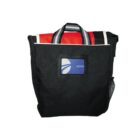 Black travel bag with a colorful towel partially packed inside.