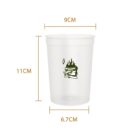 Transparent cup with green graphic, measuring 9cm wide and 11cm tall.
