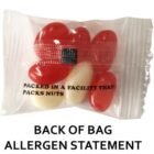 A clear bag with red and white jelly beans labeled Packed in a facility that packs nuts.