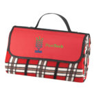 Folded red plaid picnic blanket with a handle and PineTech logo.