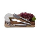 Cheese board with Brie, grapes, and three cheese knives on a wooden board.