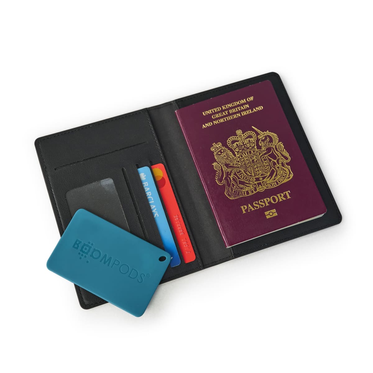 Open passport holder with UK passport, bank card, and blue card visible.