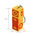 Yellow and red box-shaped keychain, 6x2x2 cm, with heart and circle designs.