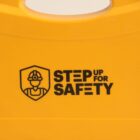 Yellow safety sign with Step Up for Safety and worker icon.