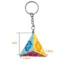 Pyramid-shaped keychain with colorful designs and measurements labeled.