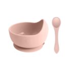 Pink silicone baby bowl with suction base and matching spoon on a white background.