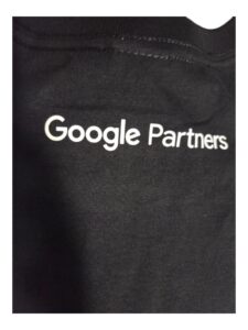 Close-up of Google Partners on a black tee shirt in white text.