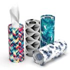 Four cylindrical tissue boxes with different geometric and floral patterns.