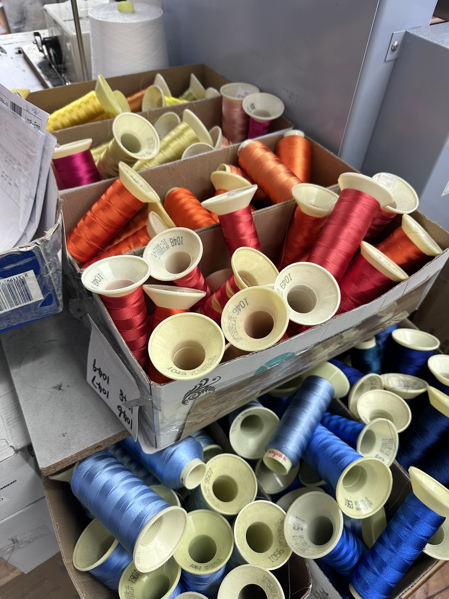 Behind the scenes: Spools of bright thread organized for embroidering logos in Australia.