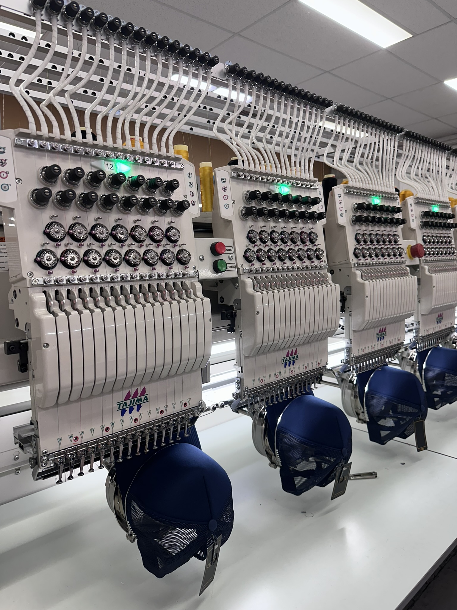 Behind the scenes: Caps in Australia being embroidered with logos by an automated machine.