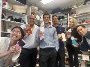 Sydney team members. 6 Creative directors standing in a promotional item showroom