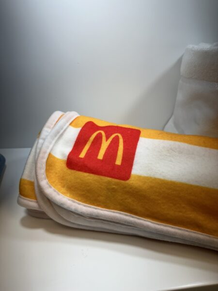 A folded towel with a yellow stripe and red McDonalds logo offers top brands merch inspiration.