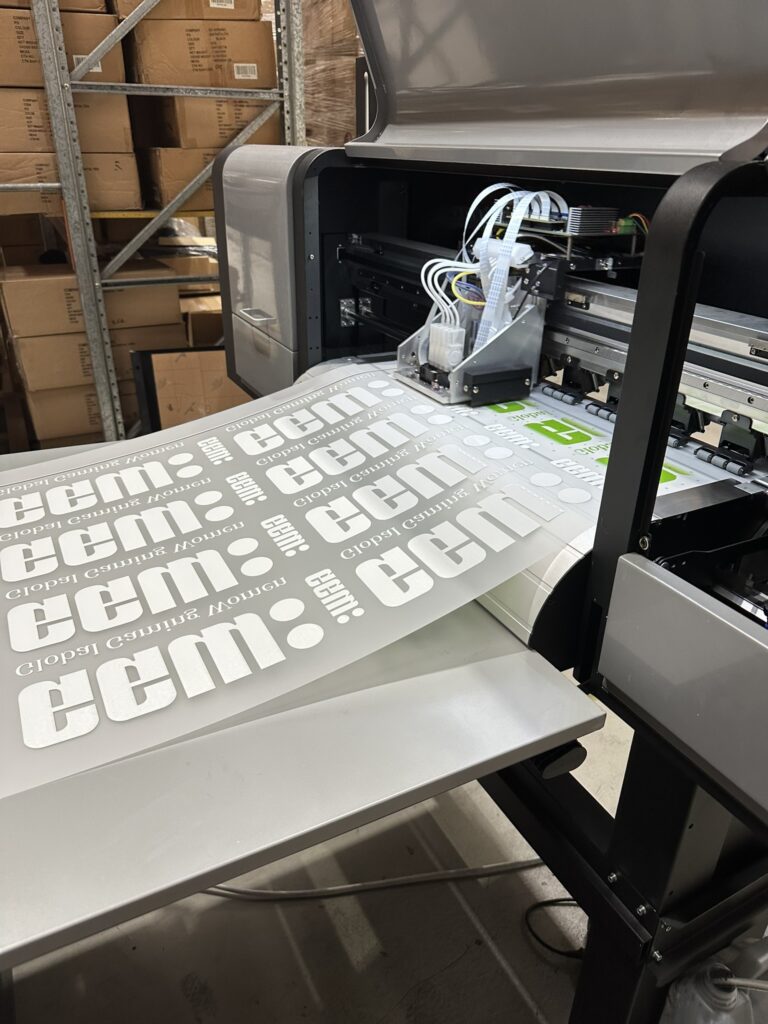 Printer producing adhesive transfer labels in a warehouse setting.