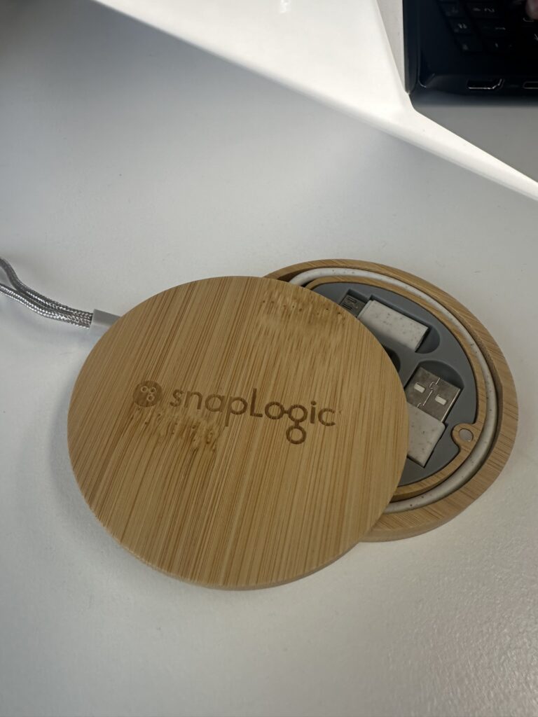 Round bamboo USB hub with SnapLogic logo, perfect for company needs on a white desk.