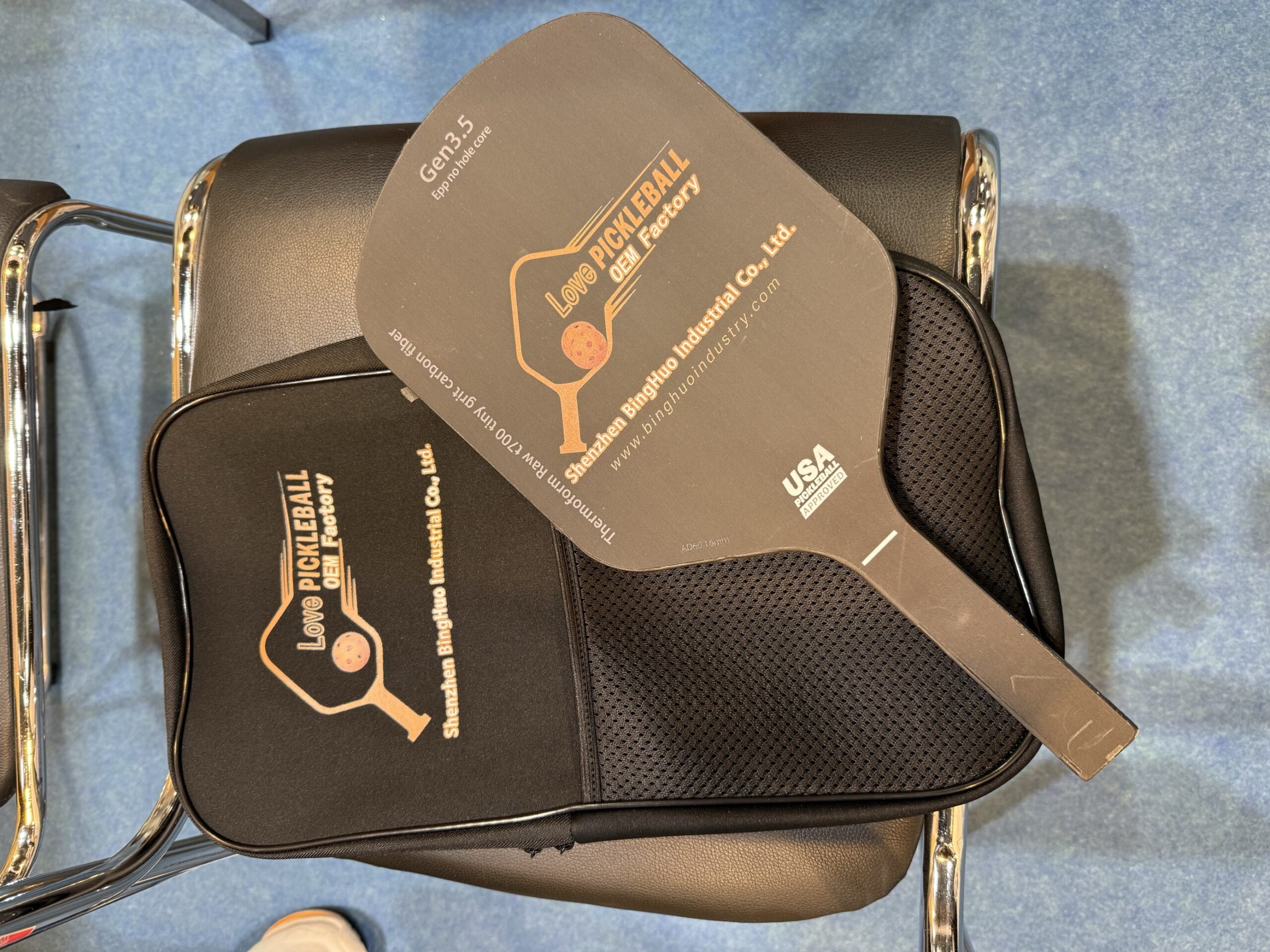 Black pickleball paddle and case on chair—perfect for B2B product sourcing amid the pickleball craze.