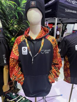 Mannequin in a colorful hoodie with Re-Loved Apparel logo and APPA 2025 beanie at indoor event.