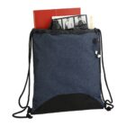 Blue drawstring bag with books and eyeglasses peeking out from the top.