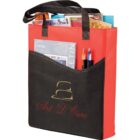 Red and black tote bag with various magazines and pens inside front pocket.