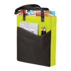 Green and black tote bag filled with magazines and pens.