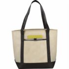 Beige tote bag with black straps and a yellow patterned item peeking out of the front pocket.