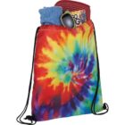 Colorful tie-dye drawstring bag with sunglasses, cap, and clothes peeking out.