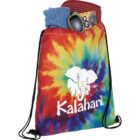 Tie-dye bag with Kalahari logo, containing a cap, sunglasses, book, and blue shirt.