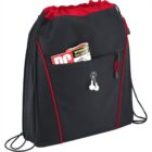 Black drawstring bag with red accents, headphone wires, and a magazine in the front pocket.
