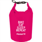 Bright pink dry bag with BIKE EAT SLEEP REPEAT Pedal text in white.