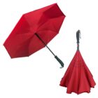 Red inverted umbrella open on left, closed and standing upright on right.